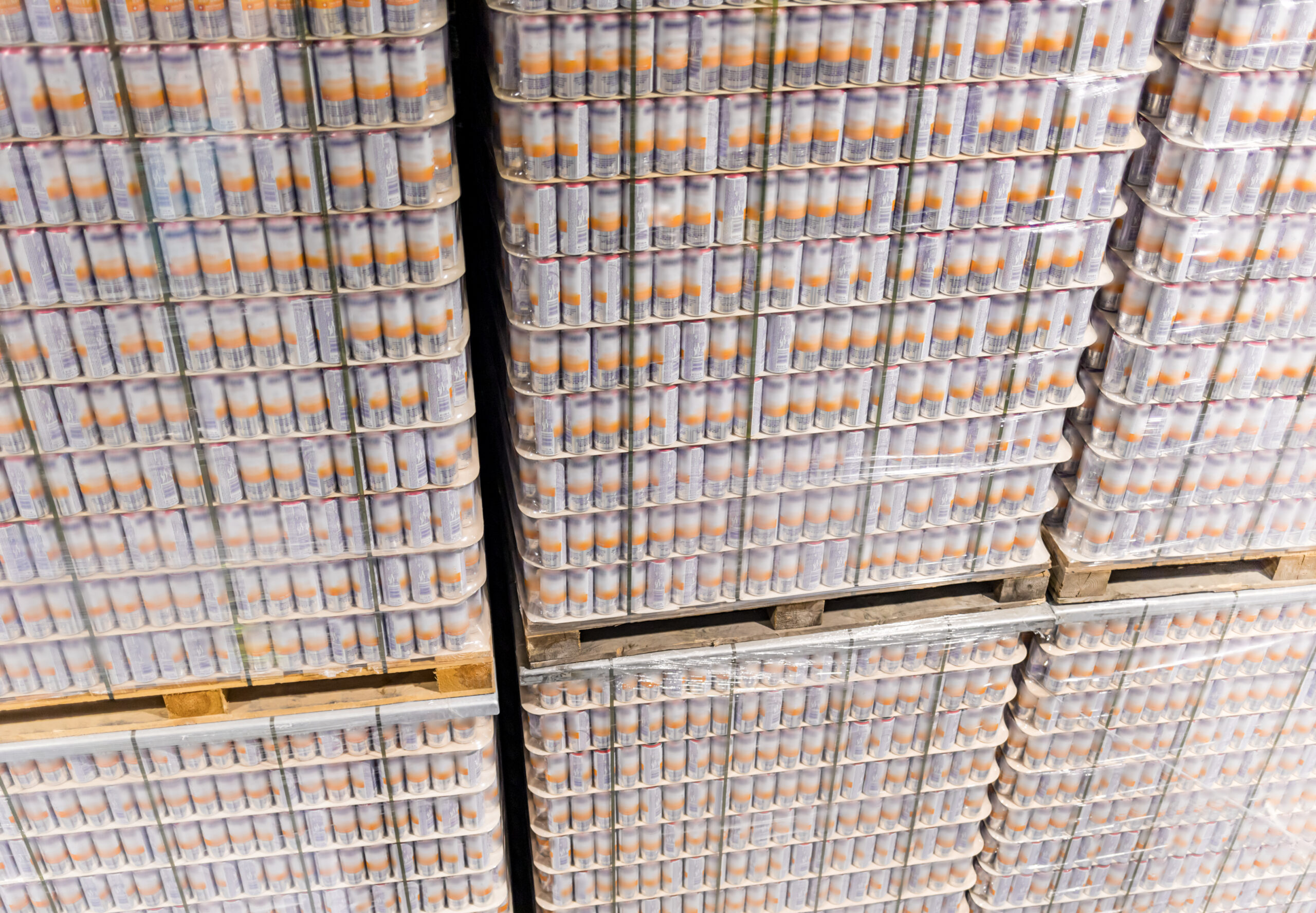 Tall stack of products on pallets in warehouse